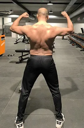 Ashish seen from behind, close crop, back muscles flexed